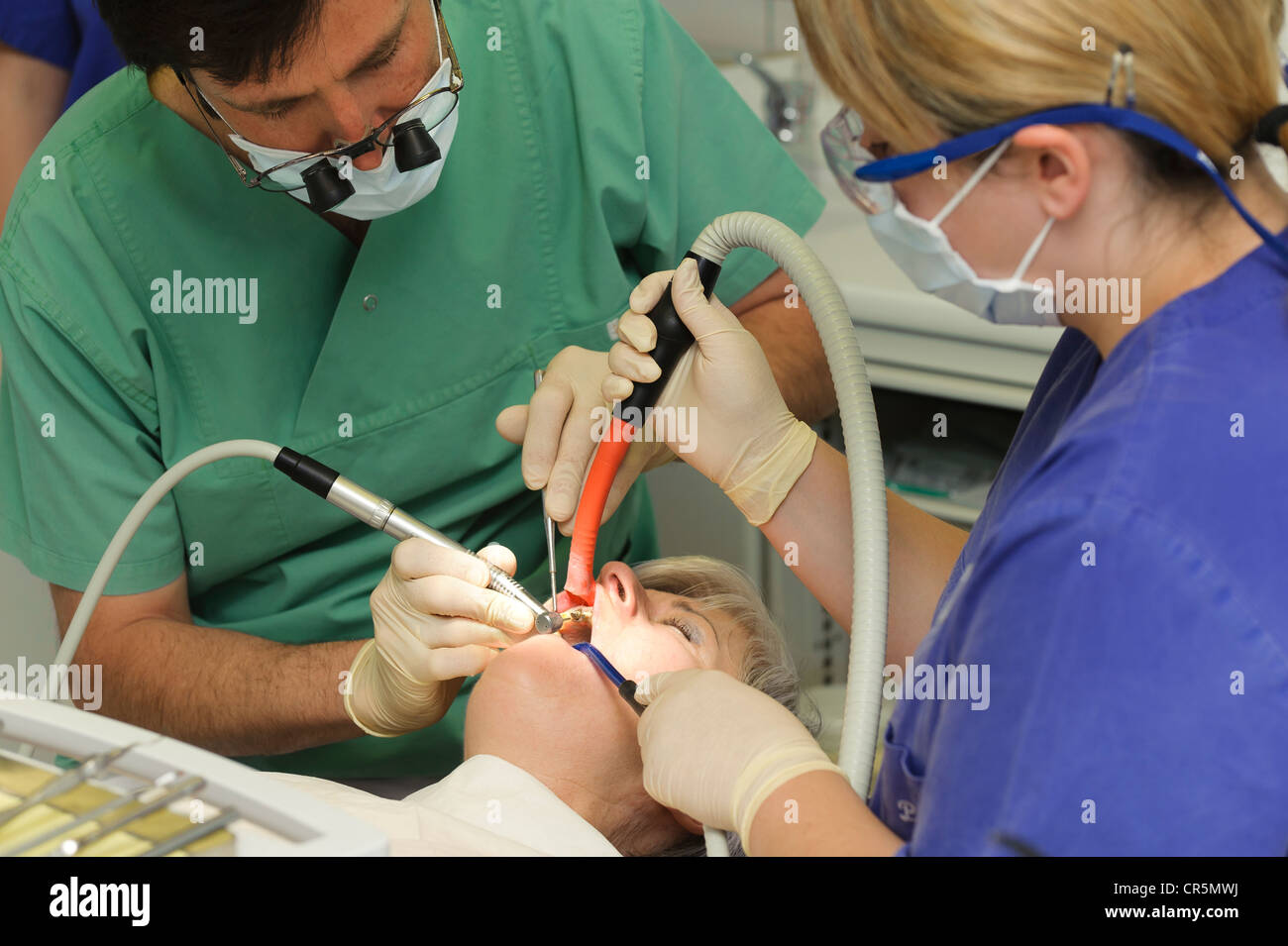 Dentiste et un assistant avec un patient pendant le traitement dentaire Banque D'Images