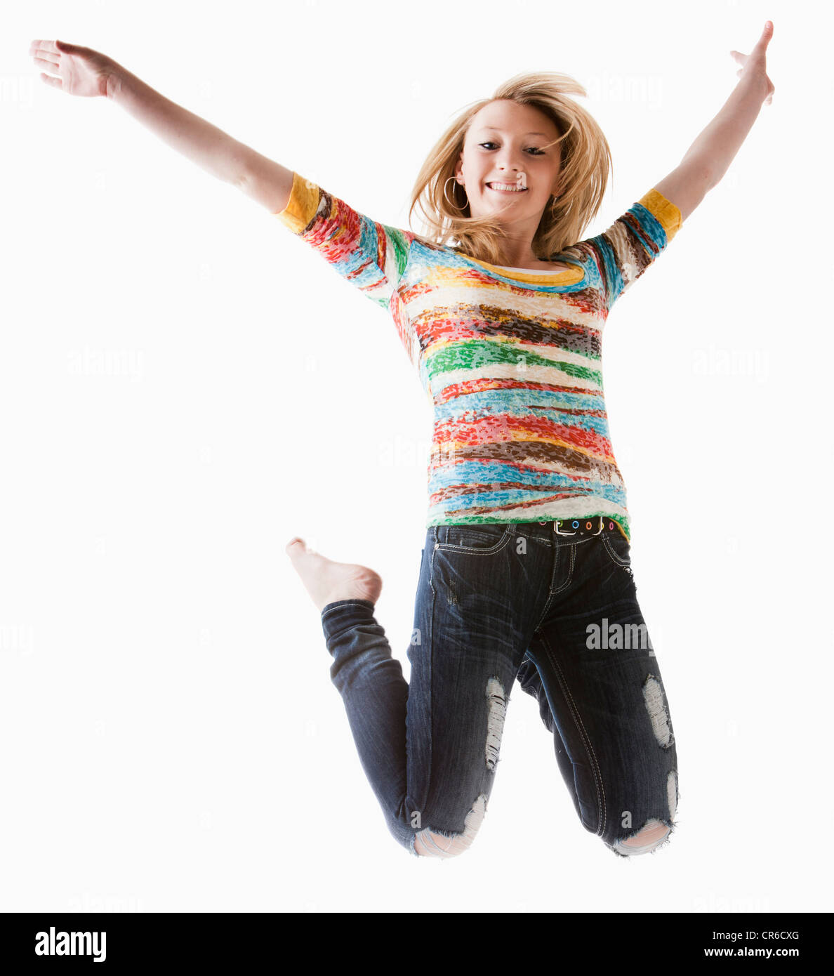 Portrait of Girl (12-13) jumping with arms raised Banque D'Images