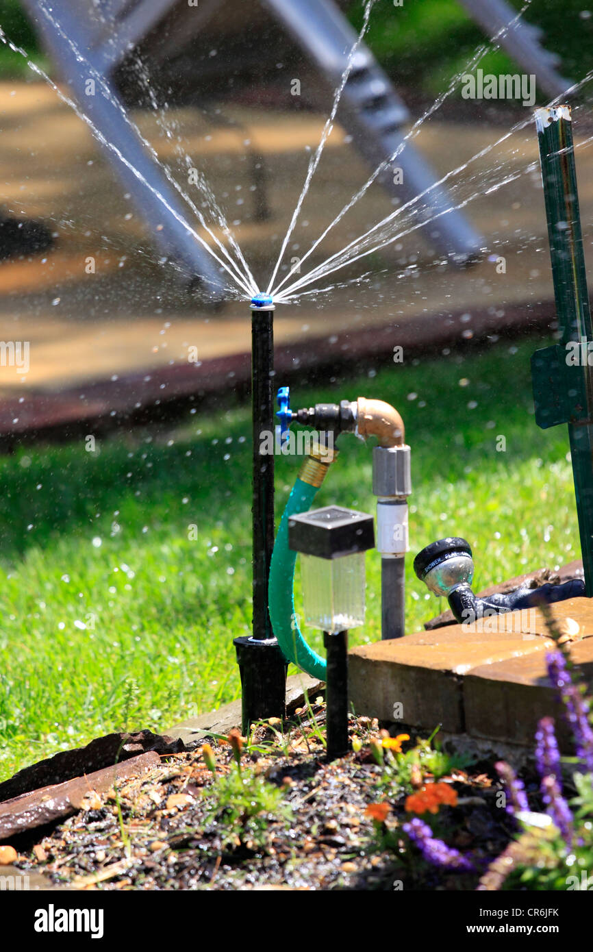 En arrière-cour de sprinkleur suburban home Long Island NY Banque D'Images