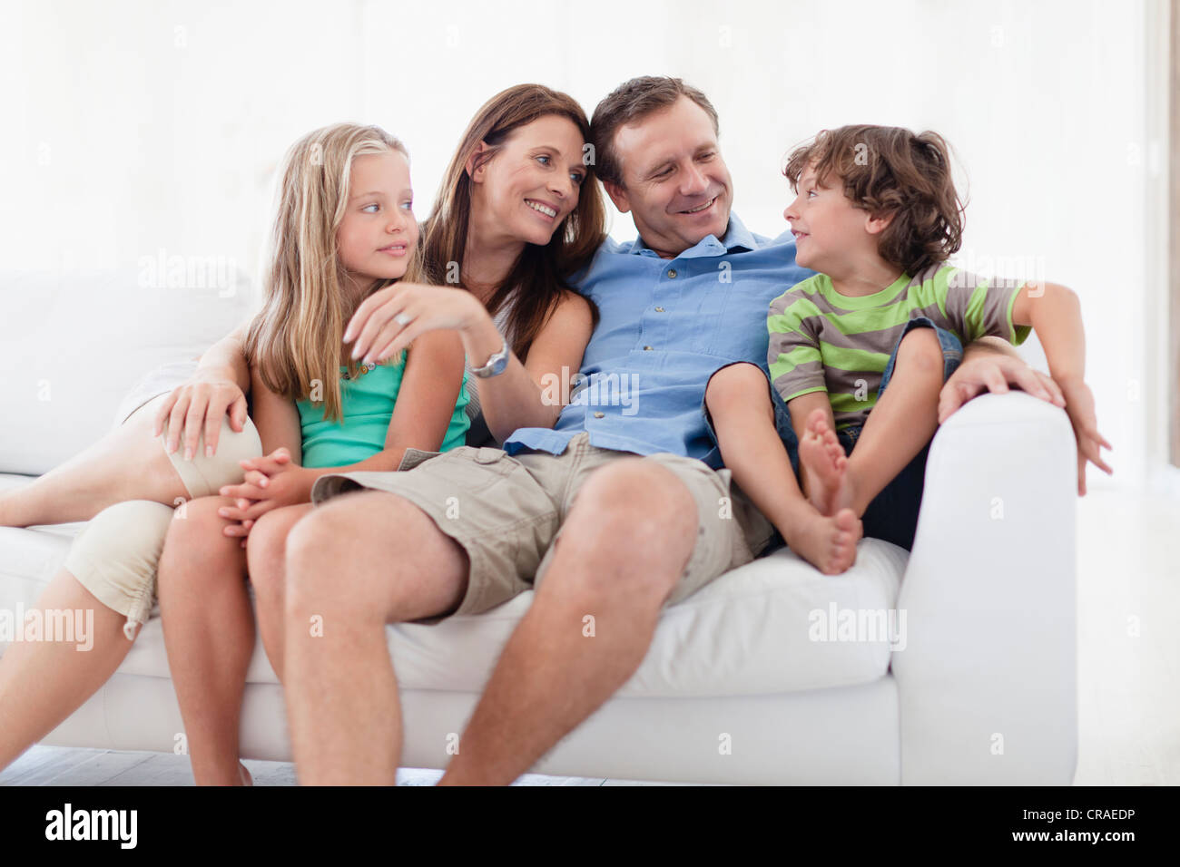 Family relaxing together on sofa Banque D'Images