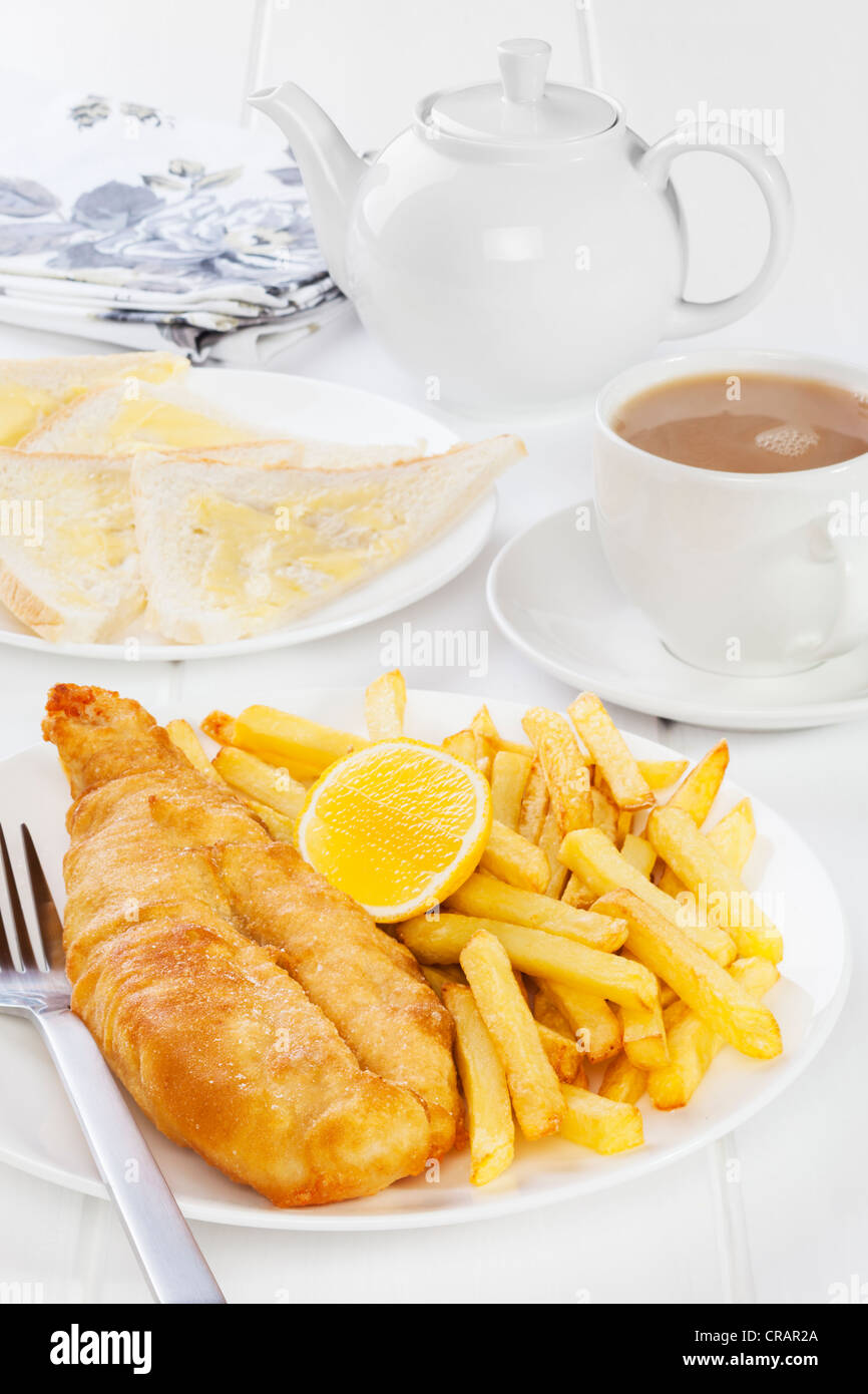 Poisson-frites servi avec pain beurré et un pot de thé. La station préférée du seigneur. Banque D'Images