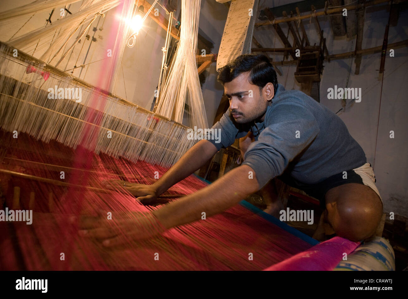 L'homme à un métier à tisser le tissage traditionnel de la soie Benares, vieille ville de Varanasi, Uttar Pradesh, Inde, Asie Banque D'Images