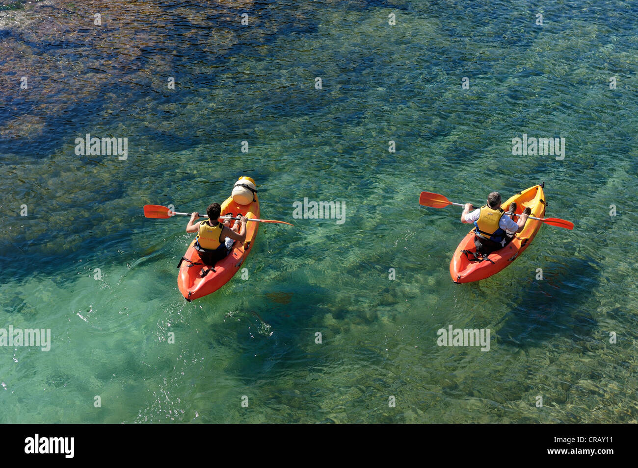 Père et fils en kayak dans les eaux cristallines de cala santa galdana menorca espagne iles baléares Banque D'Images