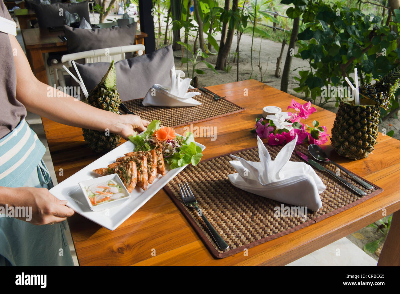 Waitress serving Thai Food, The Seven Seas Resort, Ko Kradan, Trang, Thaïlande, Asie du Sud-Est, Asie Banque D'Images