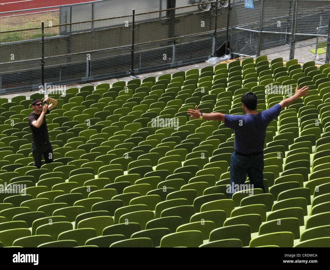 Stade olympique de Munich, l'homme est photographiée entre les sièges, l'Allemagne, Bavaria, Munich Banque D'Images