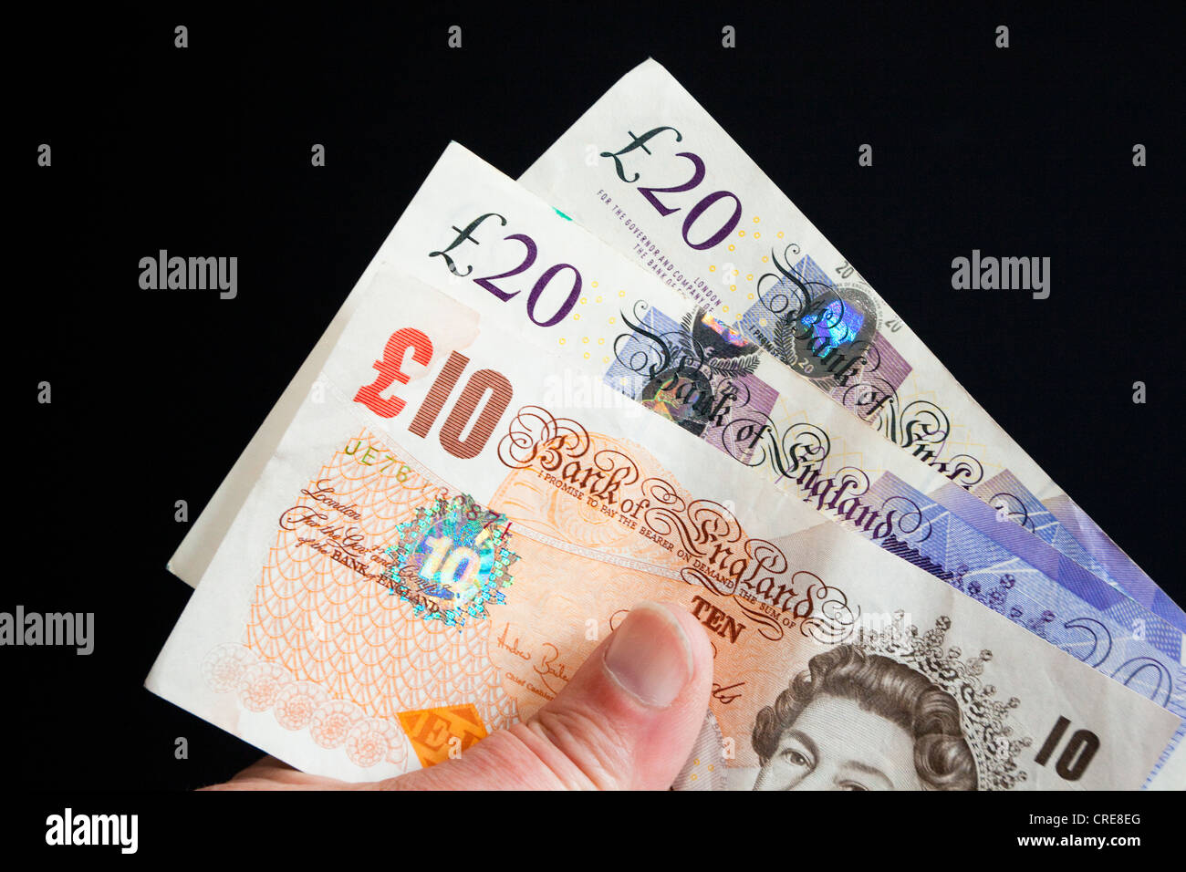 Livre Stirling notes dans la main Banque D'Images