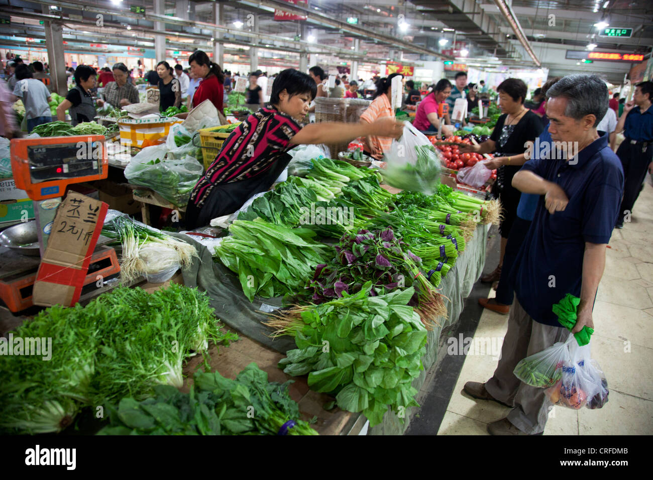 Vendeurs sur cale à l'intérieur de marché traditionnel dans une ancienne zone de style Chinois Fuchengmen, dans le district de Xicheng de Pékin, Chine. Banque D'Images