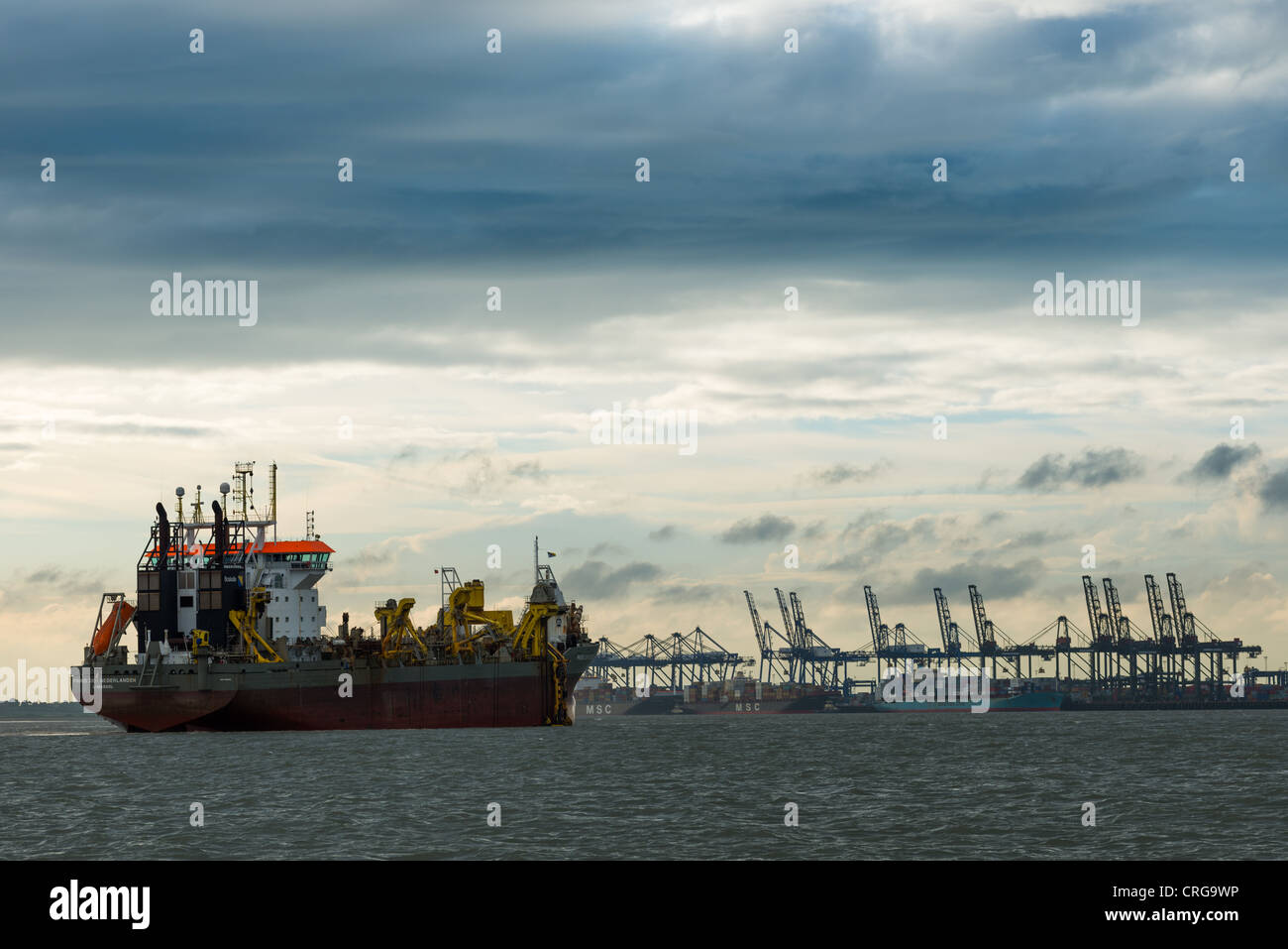 Navire s'approche des quais du port à conteneurs de Felixstowe et au crépuscule, Suffolk, Angleterre. UK. Banque D'Images