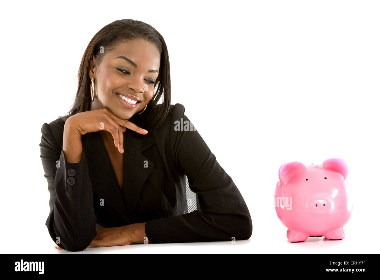 Young business woman smiling at un piggybank Banque D'Images