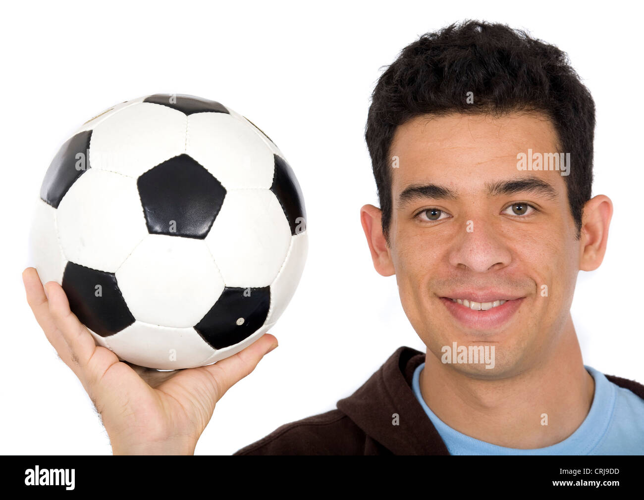 Joueur de foot en tenant une balle avec un sourire Banque D'Images