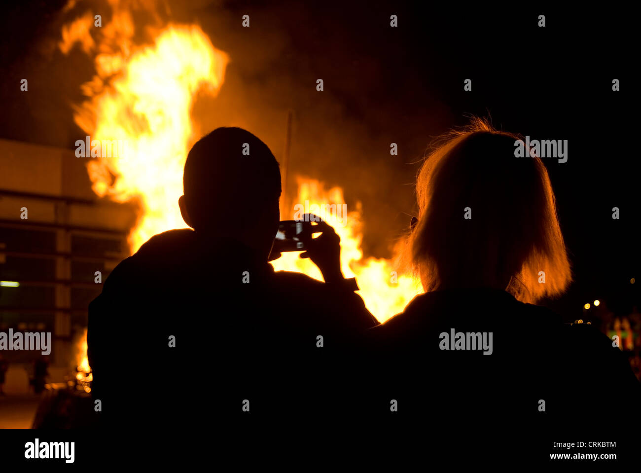 Les personnes témoins et l'enregistrement d'un feu avec un téléphone intelligent Banque D'Images
