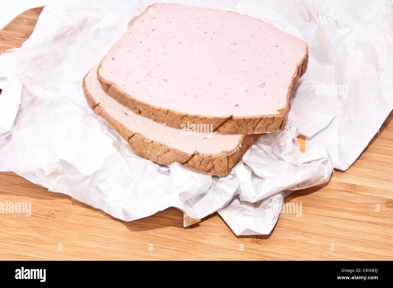 Pain de viande crue sur une planche à découper en bois Banque D'Images