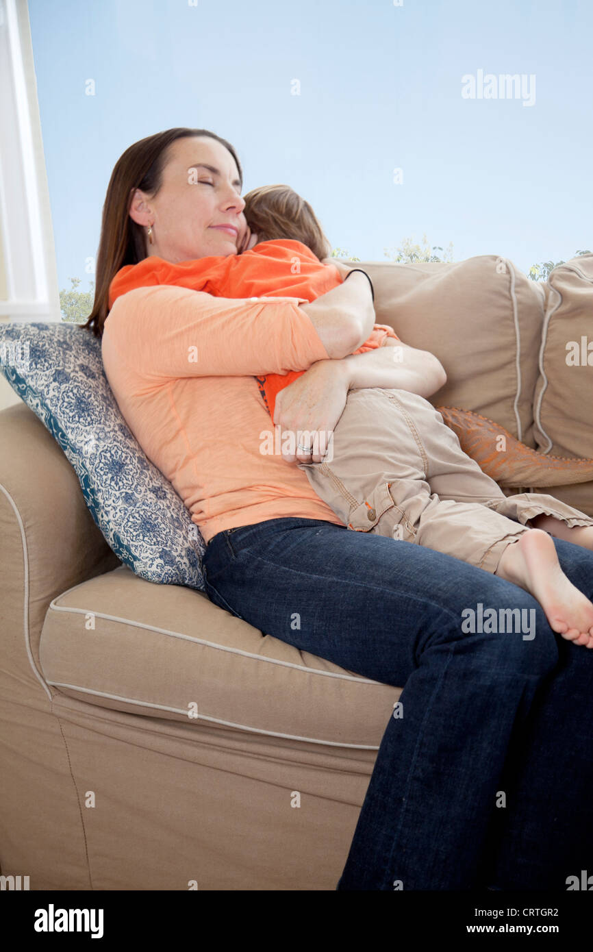Mère et fils jouant sur un canapé. Banque D'Images