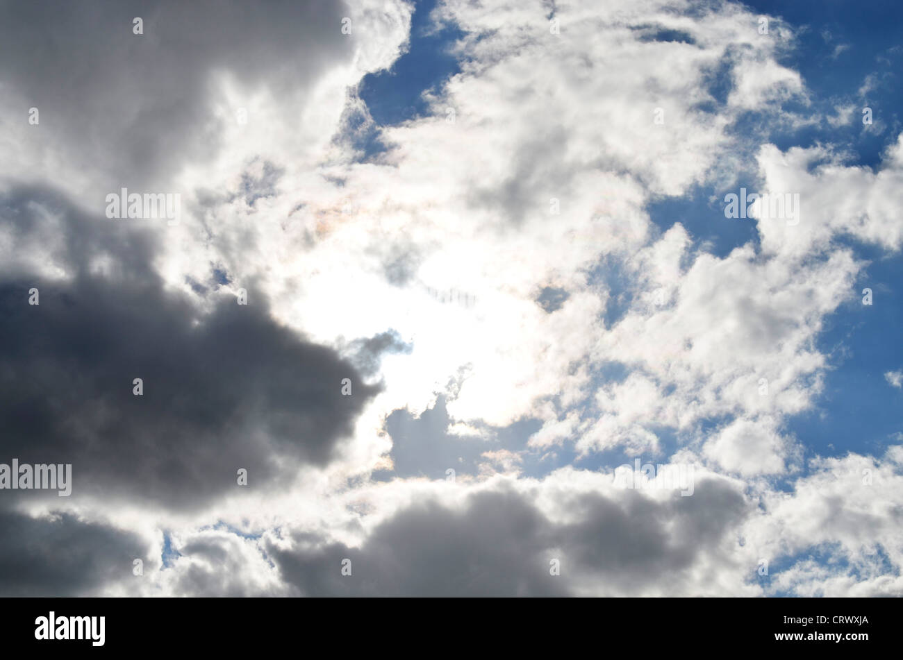 Soleil à travers les nuages gris Banque D'Images