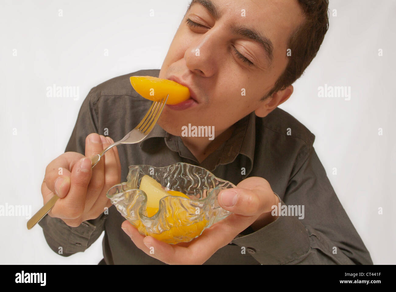 MAN EATING FRUIT Banque D'Images