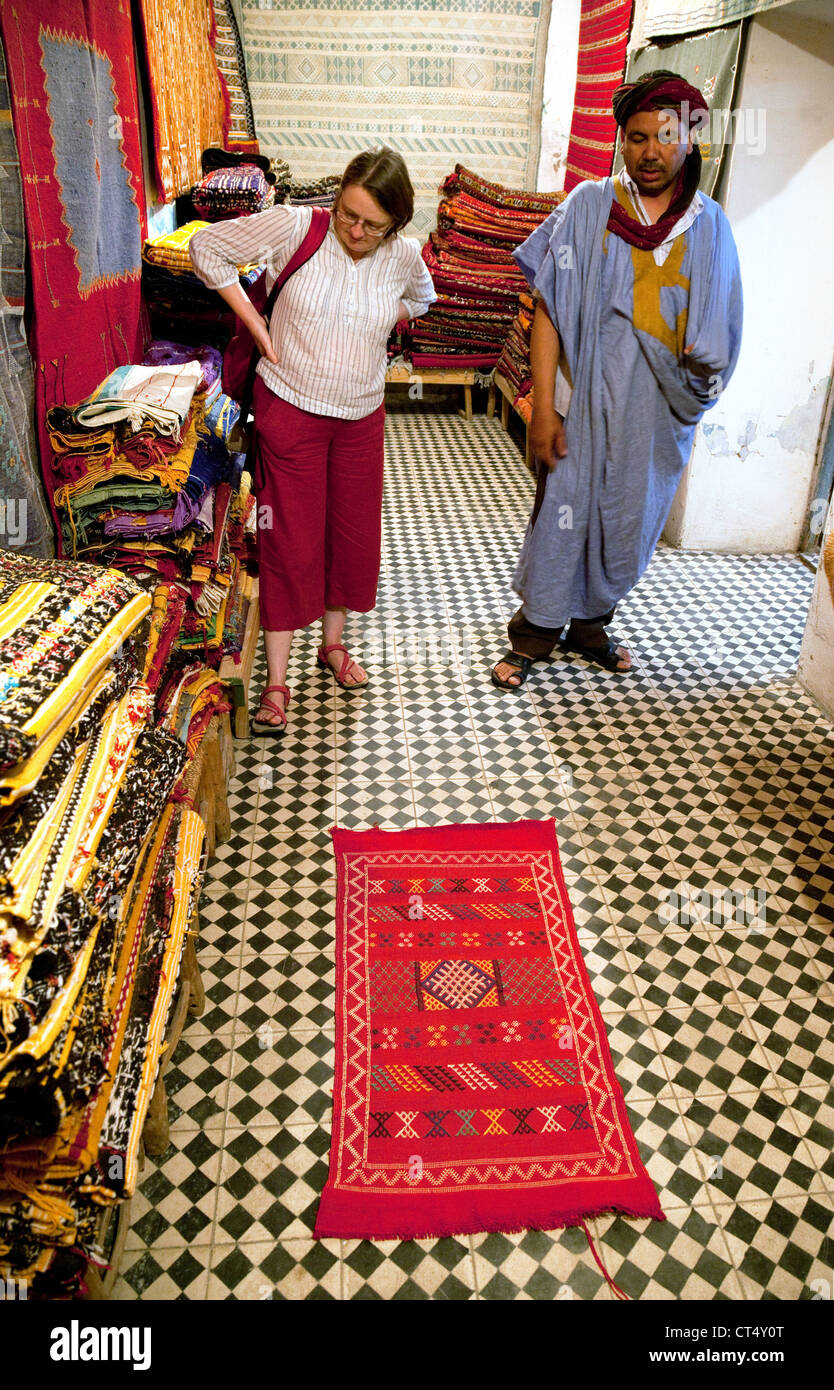Un tourisme de l'ouest d'acheter un tapis berbère d'un commerçant,  Taroudant, Maroc, Afrique Photo Stock - Alamy