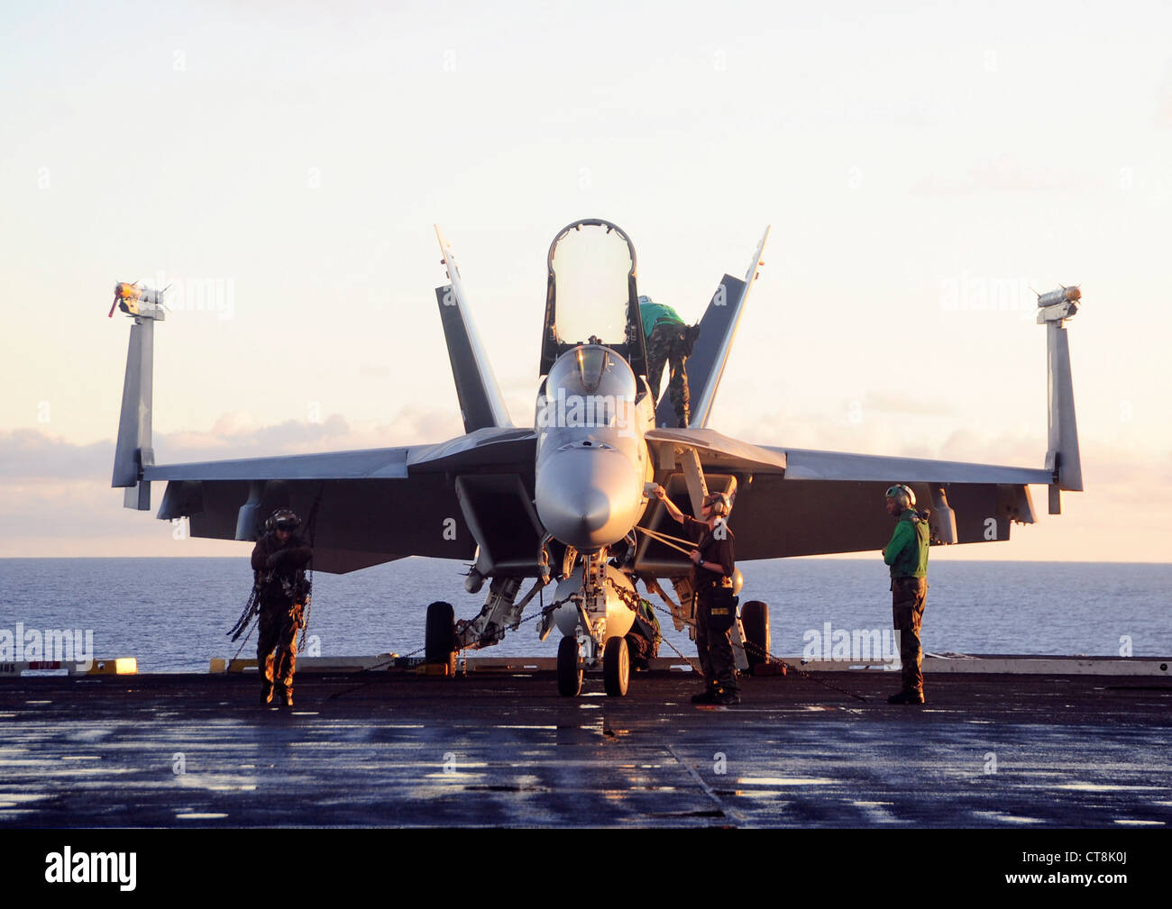 Les marins affectés à l'escadron de chasseurs Eagles of Strike (VFA) 115 effectuent l'entretien d'un F/A-18e Super Hornet sur le pont de vol du porte-avions USS George Washington (CVN 73). George Washington a quitté Fleet Activities Yokosuka le 26 mai pour commencer sa patrouille de 2012. George Washington et son aile aérienne embarquée, Carrier Air Wing (CVW) 5, fournissent une force prête au combat qui protège et défend les intérêts maritimes collectifs des États-Unis et de leurs alliés et partenaires dans la région Asie-Pacifique. Banque D'Images