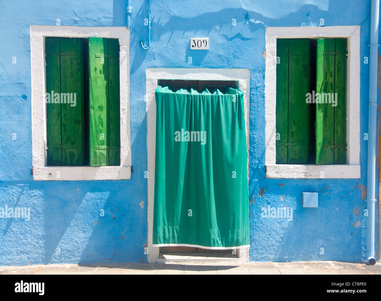 Maison typique peint coloré rez-de-chaussée fenêtres avec volets peints en vert Burano lagune de Venise Venise Vénétie Italie Banque D'Images