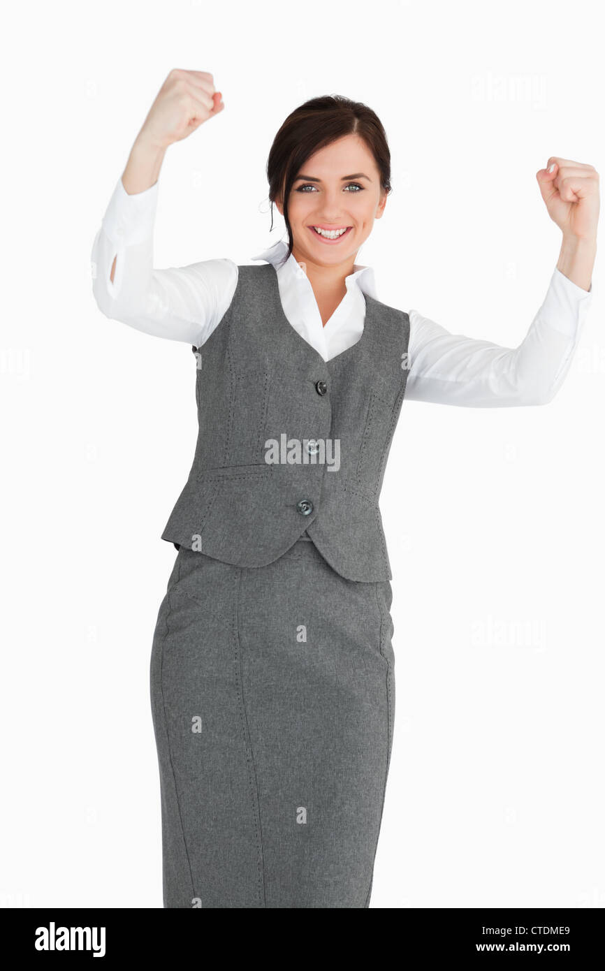 Smiling businesswoman élever ses poings Banque D'Images