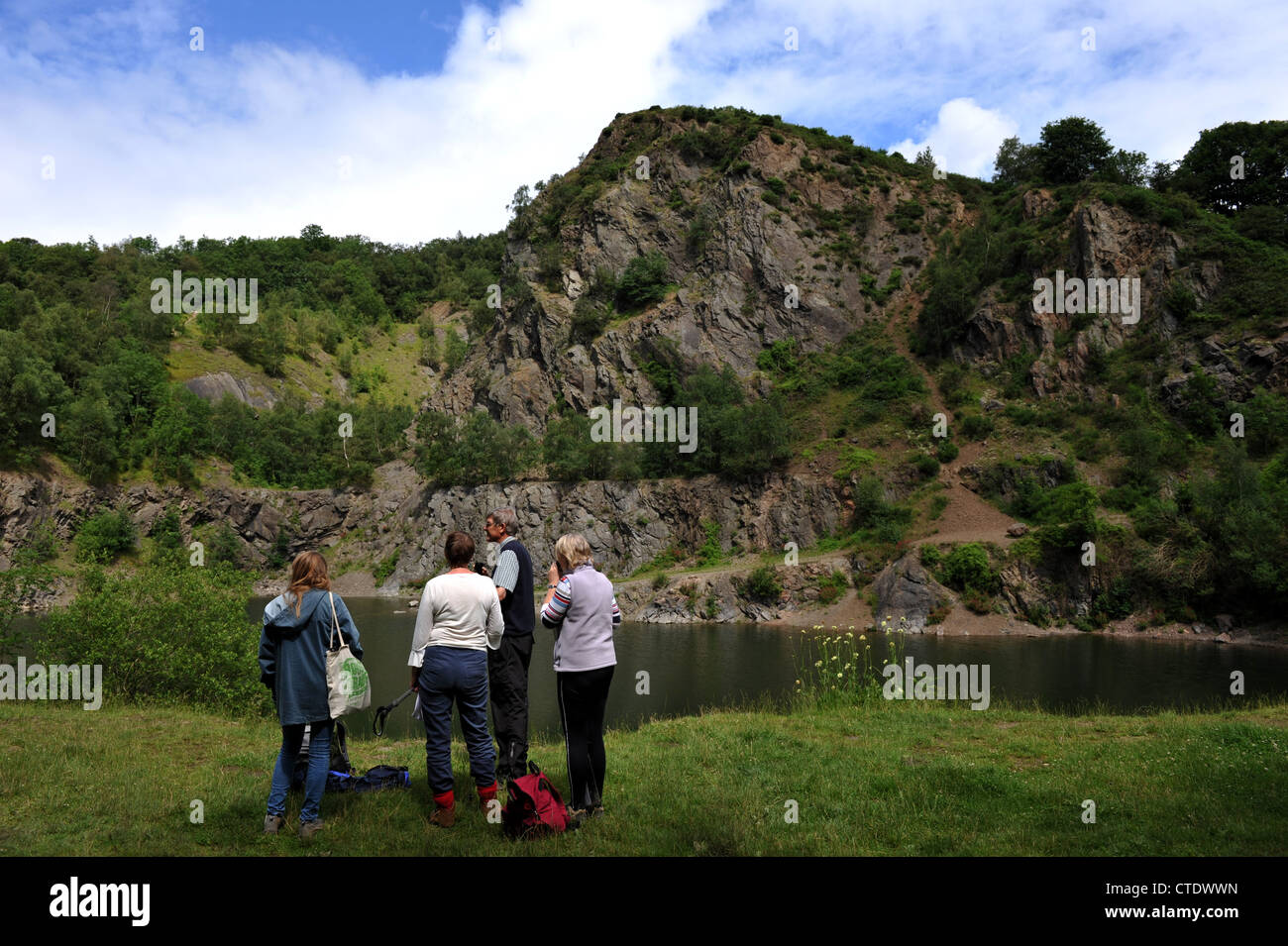 Un groupe de discuter des processus géologiques qui ont abouti à cette formation rocheuse à une carrière désaffectée dans les collines de Malvern. Banque D'Images