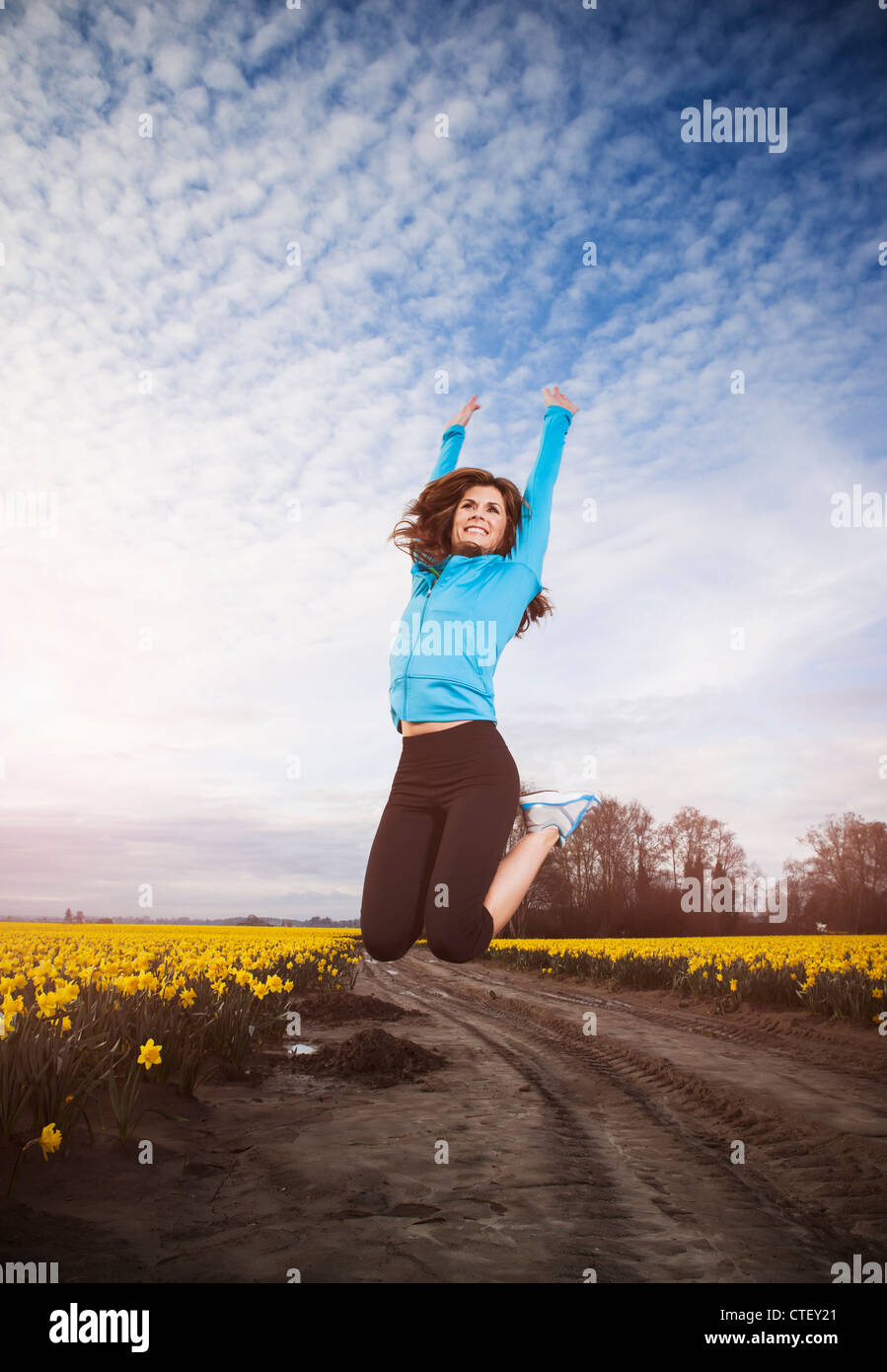 USA, Washington, Skagit Valley, la Femme en bleu ensemble en sautant dans l'air Banque D'Images