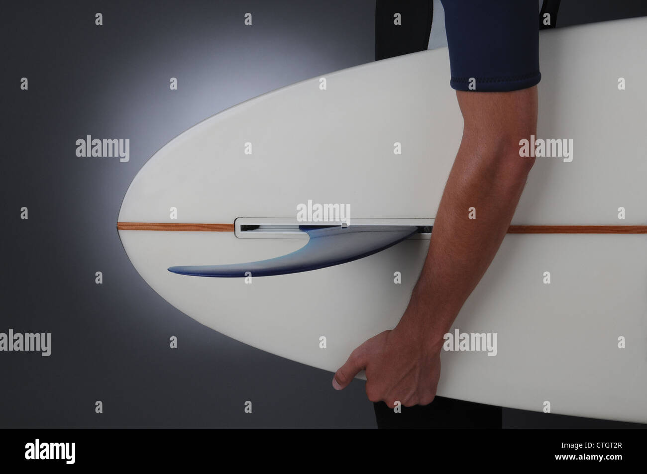 Libre d'un jeune homme portant un bikini une planche de surf. Format horizontal sur un fond gris clair à foncé Banque D'Images