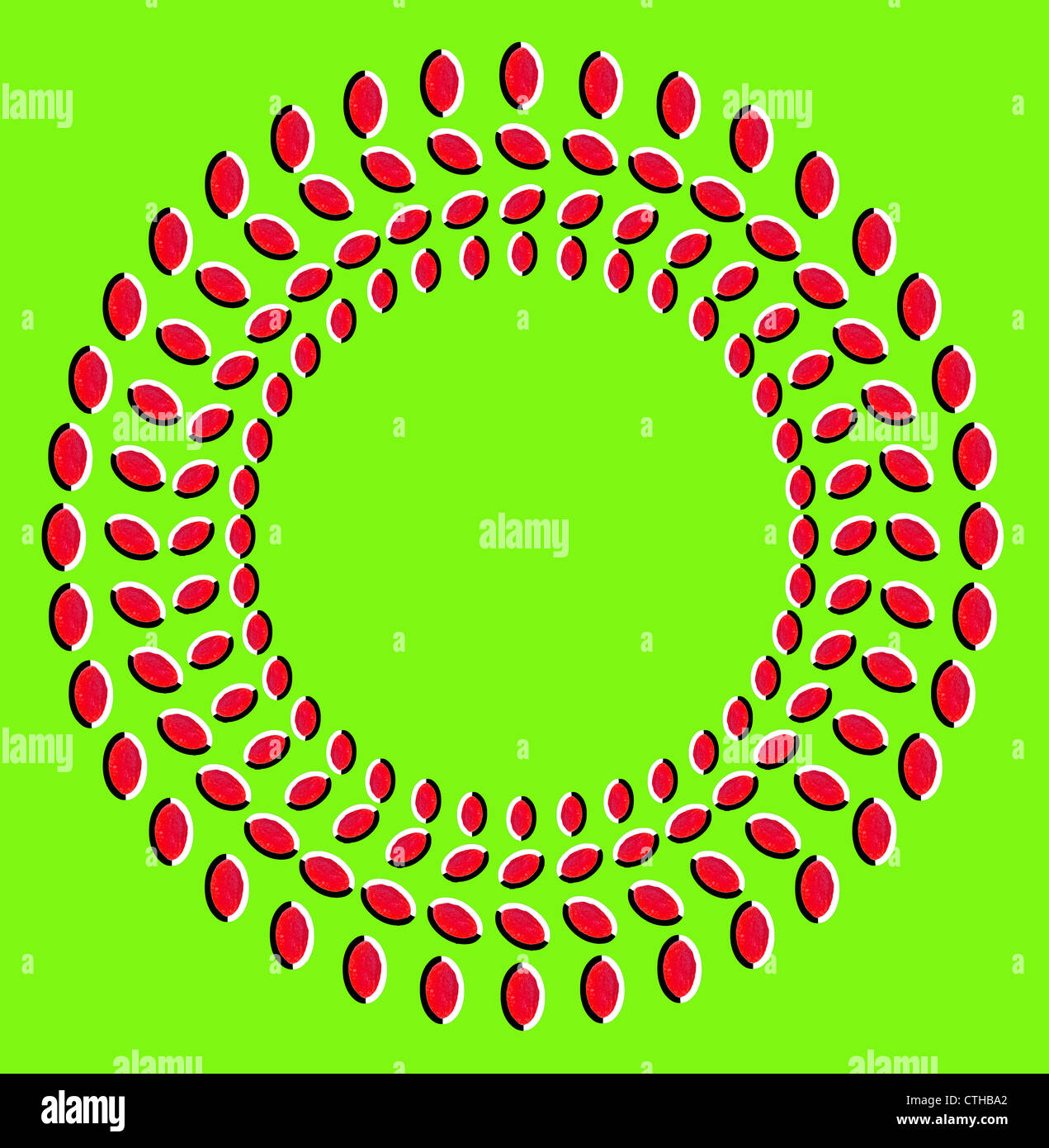 Illusion optique : rotation de cercles faits de fruits secs isolé sur fond vert Banque D'Images