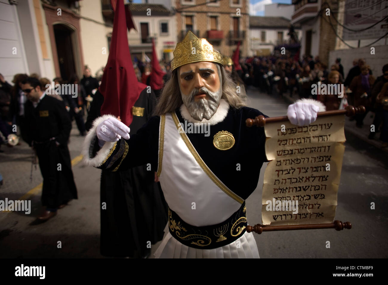 Un homme masqué vêtu comme un personnage biblique est titulaire d'un parchemin à Pâques Semaine Sainte à Puente Genil, Andalousie, Espagne Banque D'Images