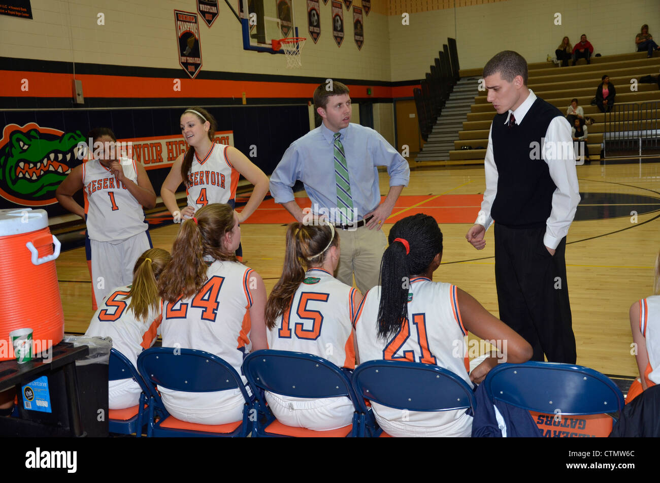 La stratégie de Coach parle à son équipe dans un match de basket-ball filles du secondaire Banque D'Images