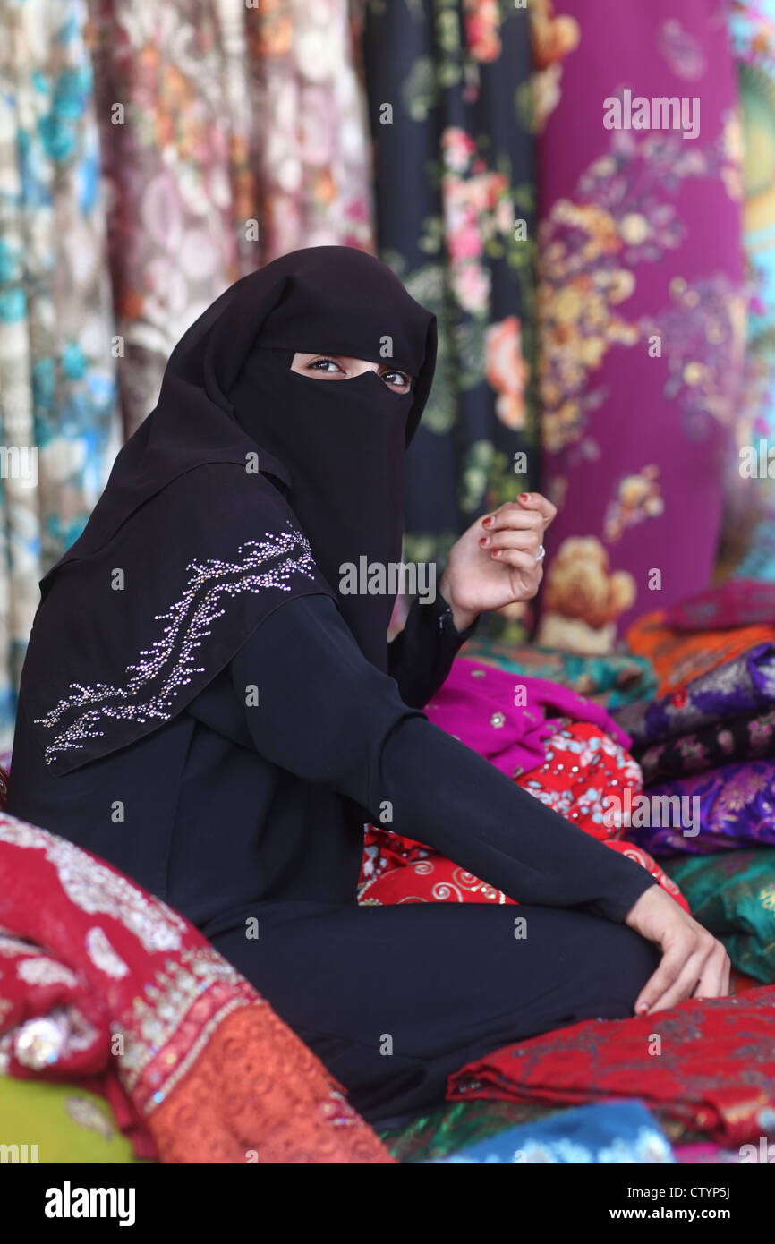 Femme musulmane, avec face cachée derrière le voile, vente de vêtements dans sa propre entreprise shop Banque D'Images