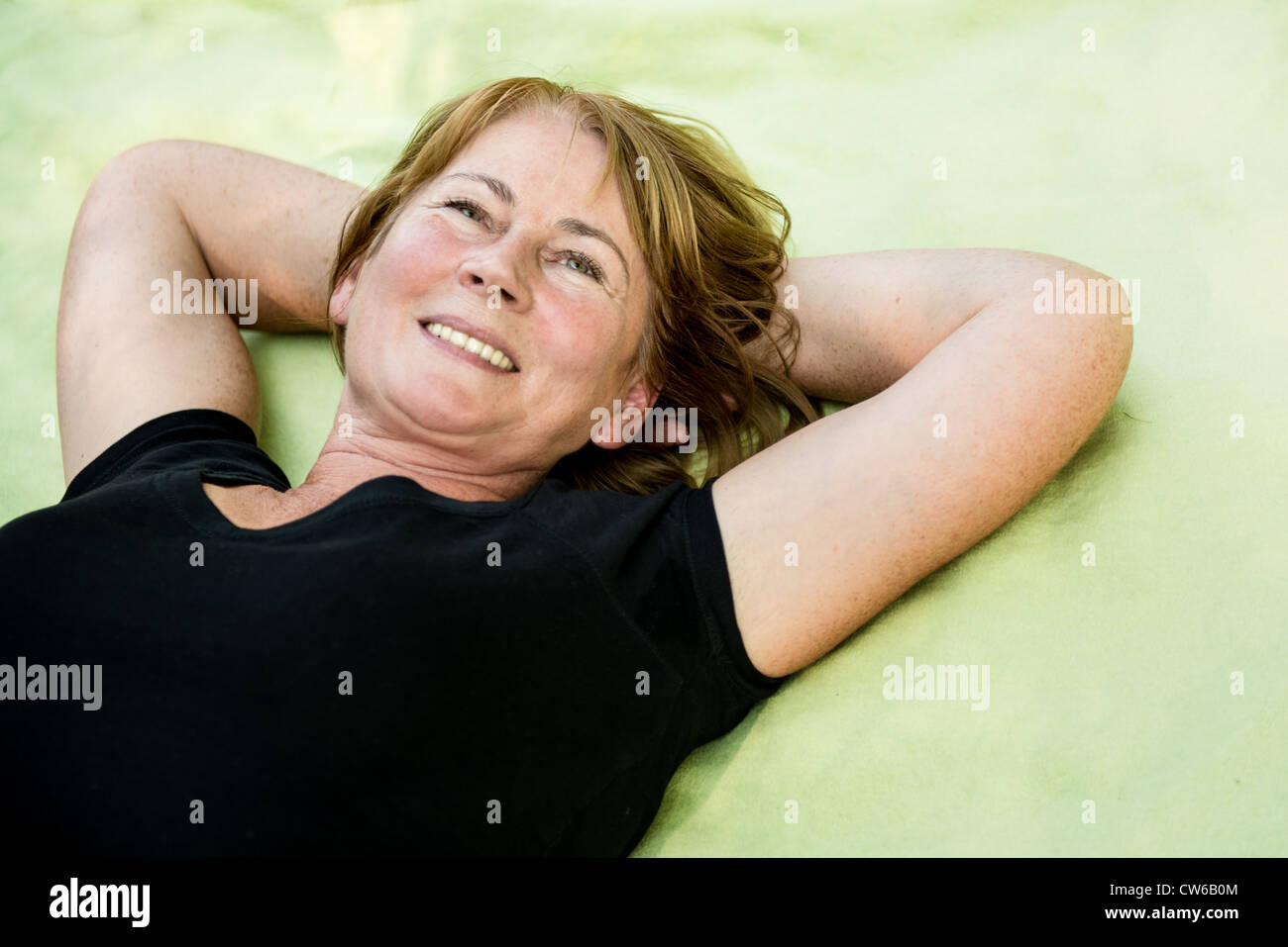 Smiling attractive woman outdoor le tapis dans la nature Banque D'Images