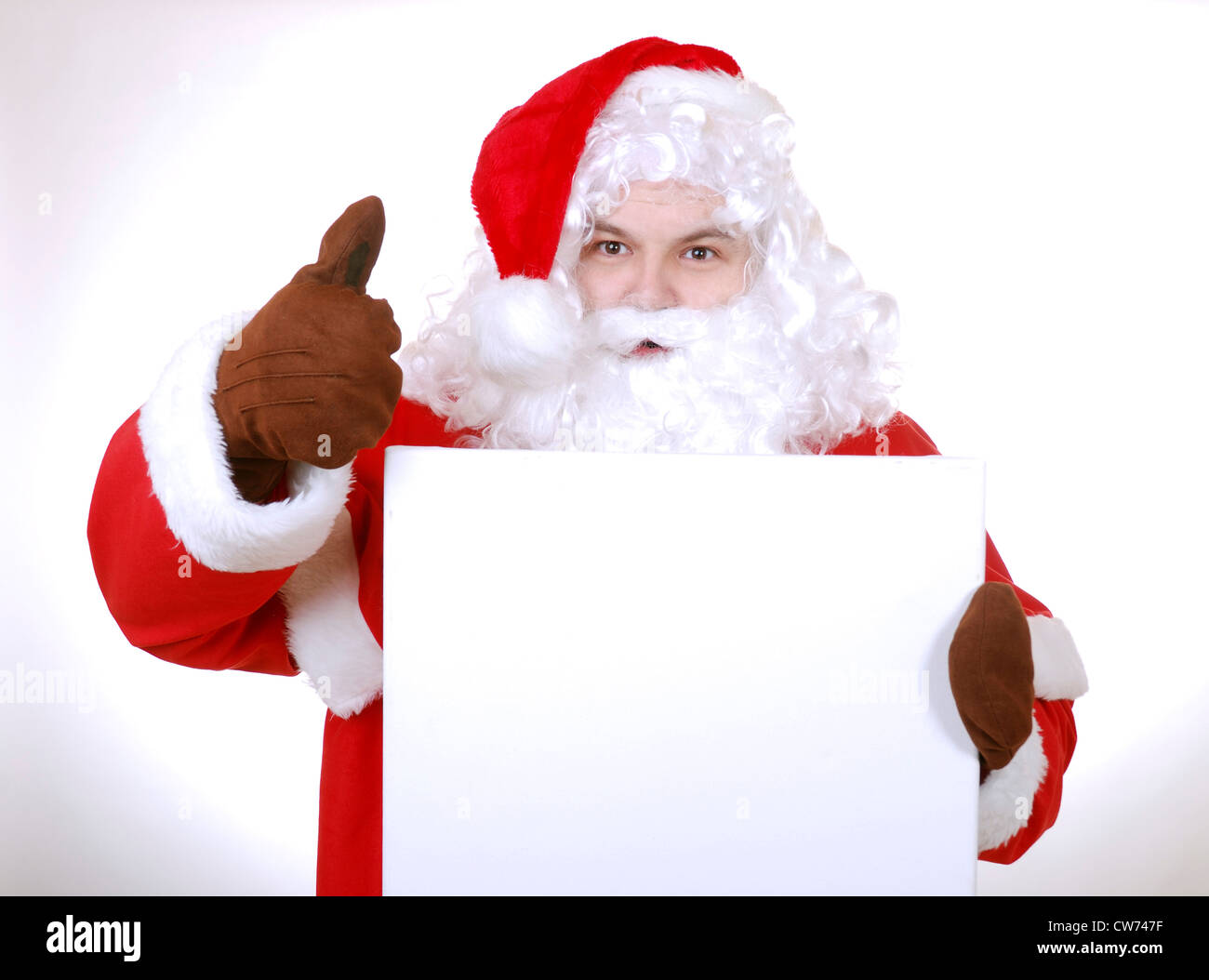 Le Père Noël avec un cadeau dans ses mains Banque D'Images