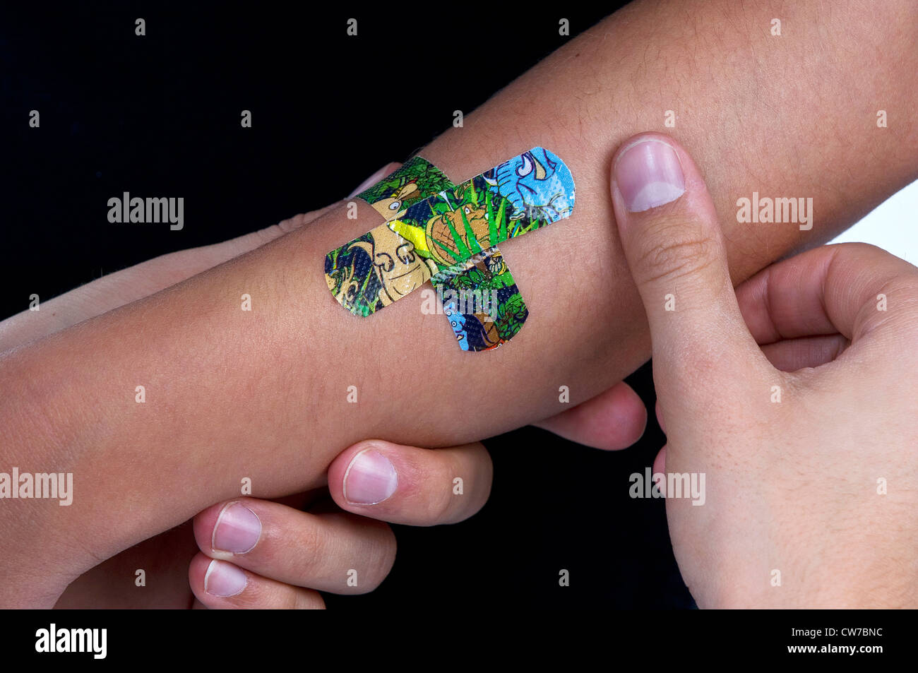 Sparadraps colorés sont collée sur un bras de l'enfant, Allemagne Banque D'Images
