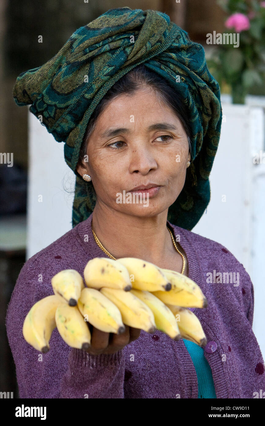 Le Myanmar, Birmanie. Femme birmane offrant des bananes à vendre, près de Bagan. Banque D'Images