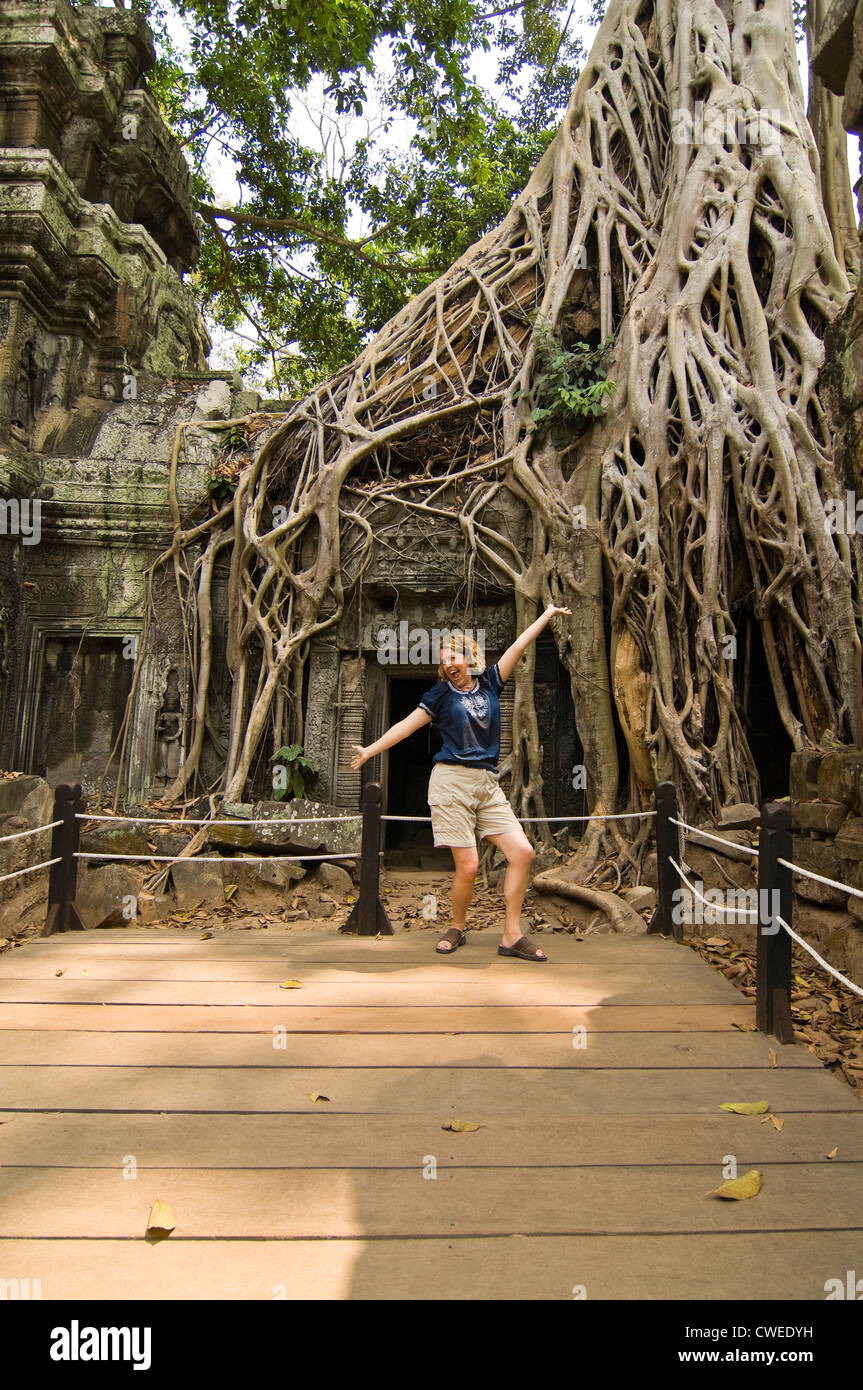Vue verticale d'un touristiques présentant à l'un des endroits emblématiques à Ta Prohm aka Rajavihara ou le temple de Tomb Raider à Ankor Thom. Banque D'Images