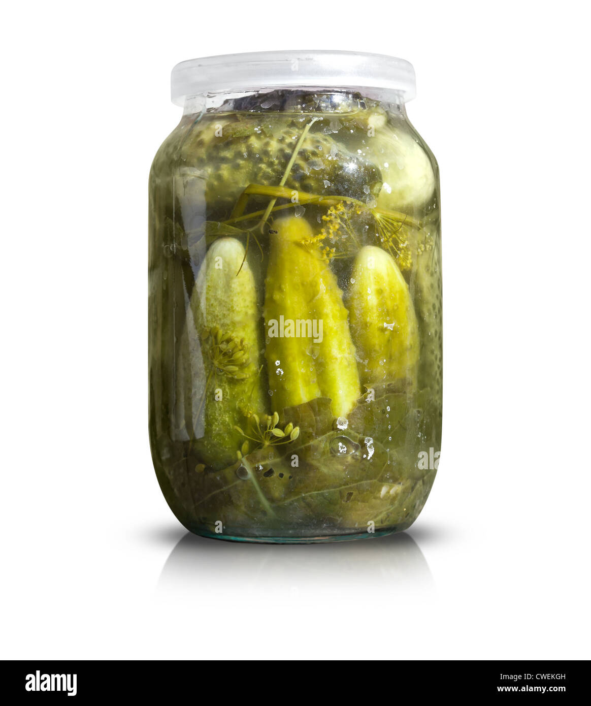 Objet La cuisine maison isolé sur blanc. Bocal en verre avec des concombres salés et sel sec tombe sur elle Banque D'Images