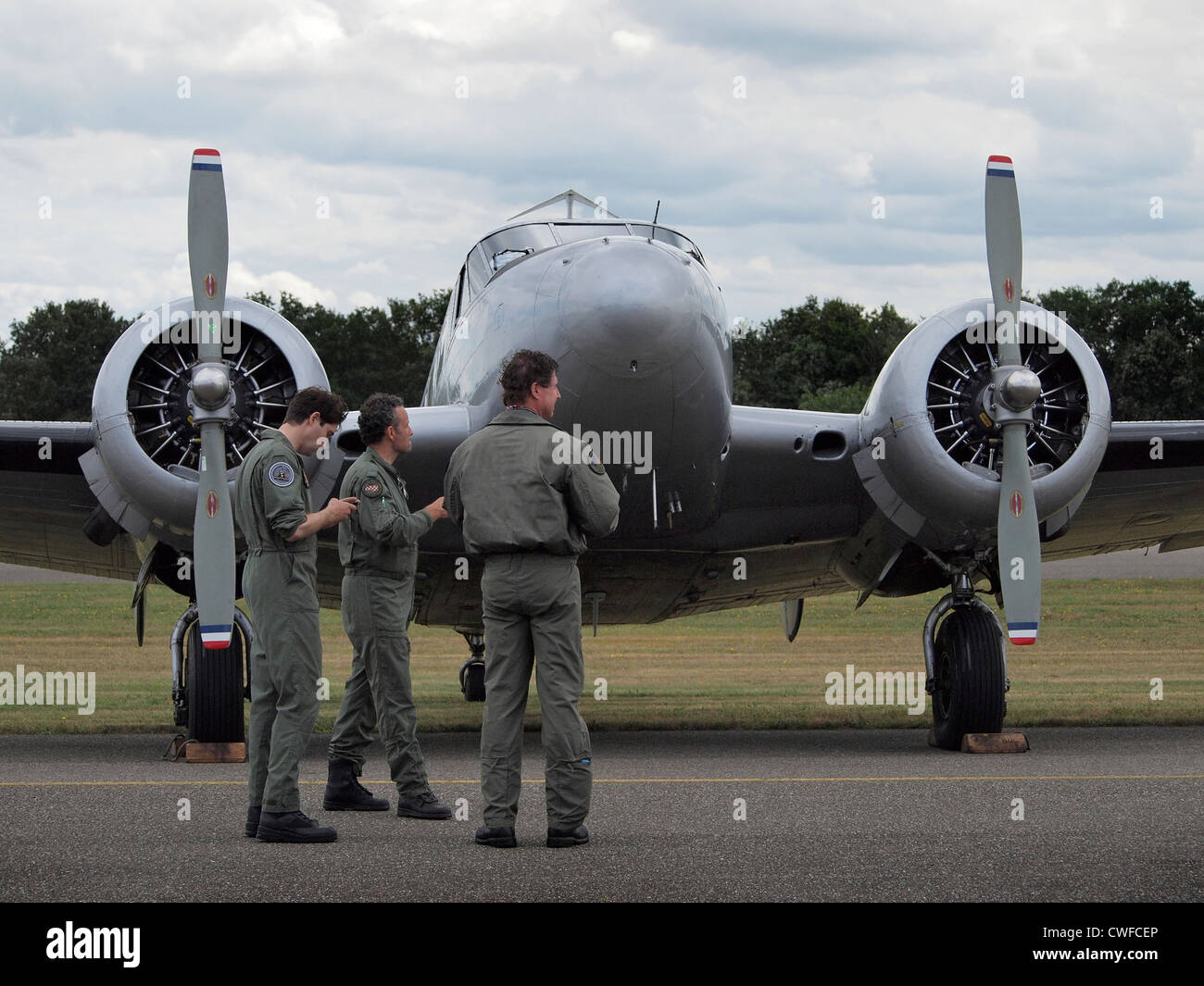 Comité permanent de l'équipage par leur classic Beechcraft B18S avion à l'aérodrome de Seppe, Pays-Bas Banque D'Images