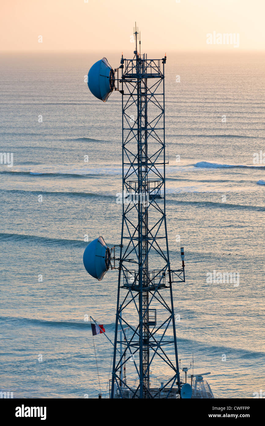 Une tour de communications radio avec des plats contre la mer au coucher du  soleil Photo Stock - Alamy