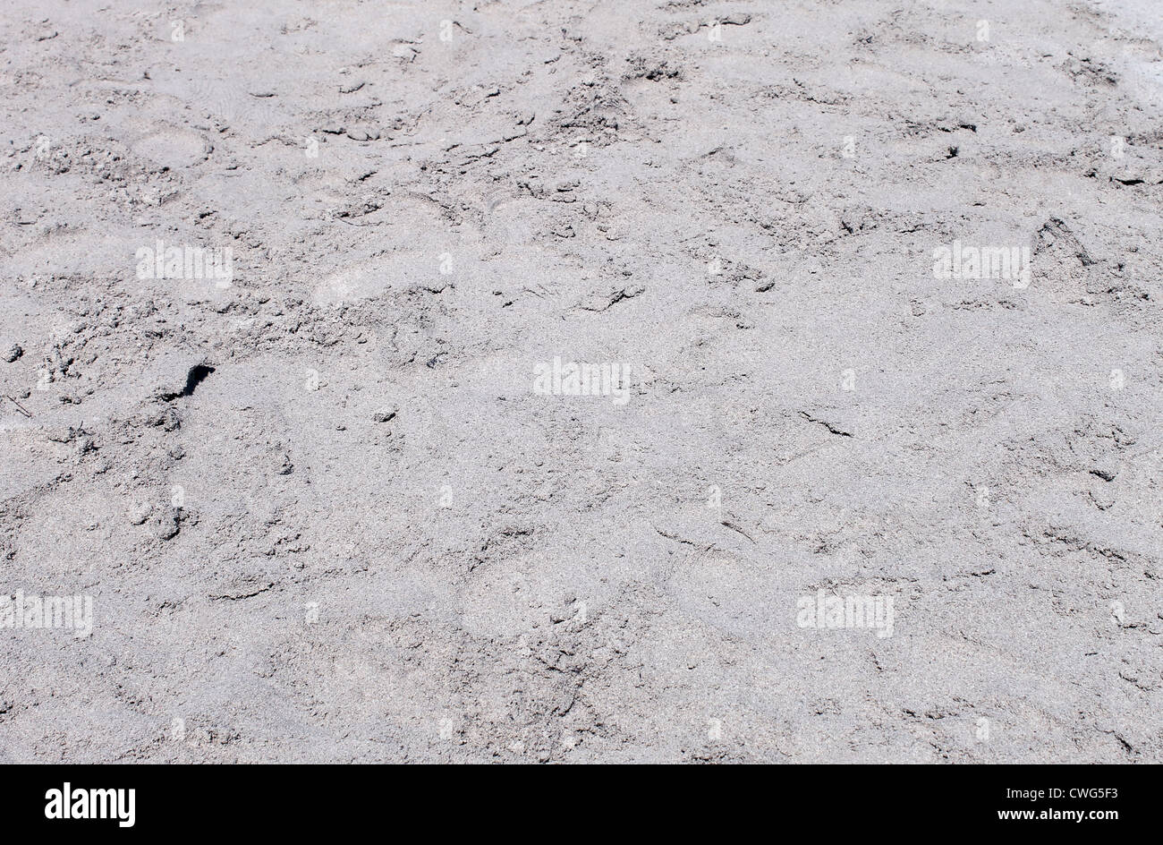Résumé fond de sable gris ou gris texturé sur la plage. Banque D'Images