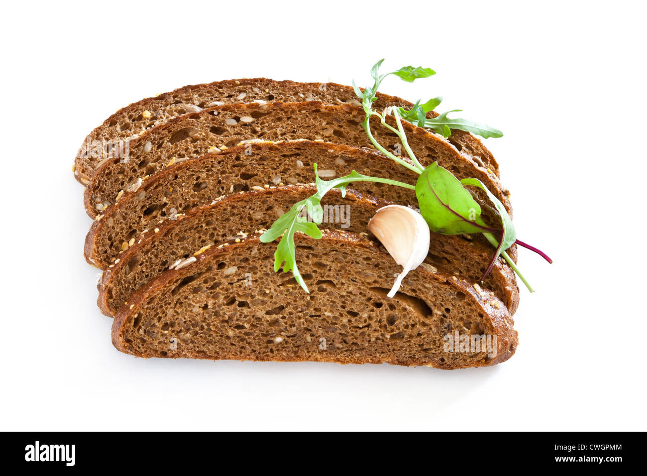 Tranche de pain brun avec gousse d'ail et vert feuille Banque D'Images