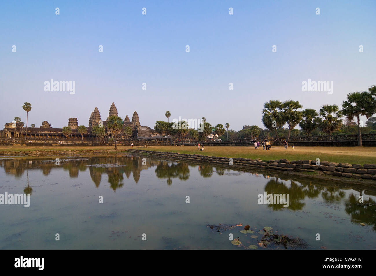 Vue horizontale de l'étonnante architecture au Prasat Angkor Wat reflété dans l'eau au lever du soleil. Banque D'Images
