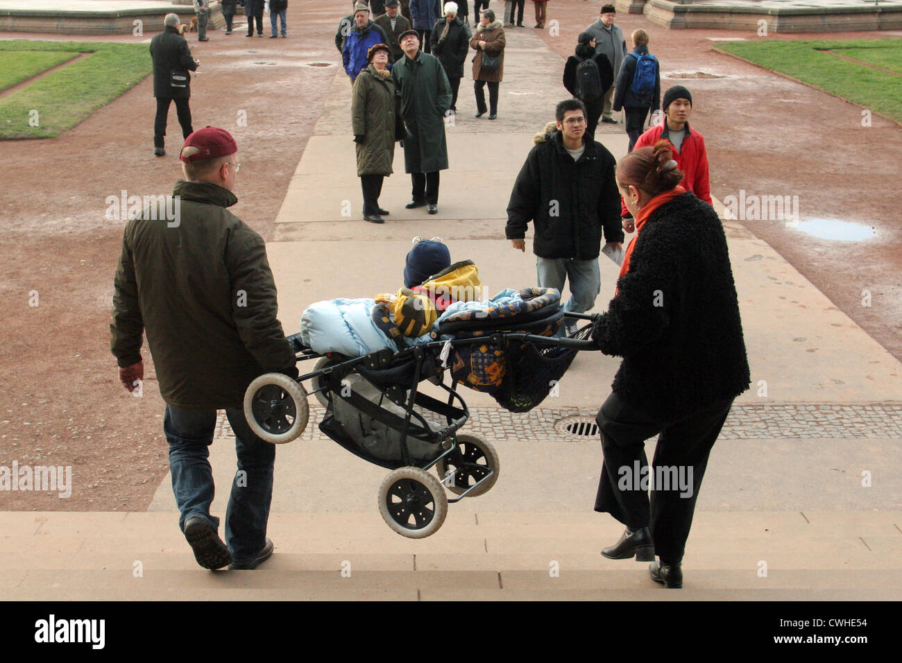 Dresde, parents portent une poussette dans un escalier Banque D'Images