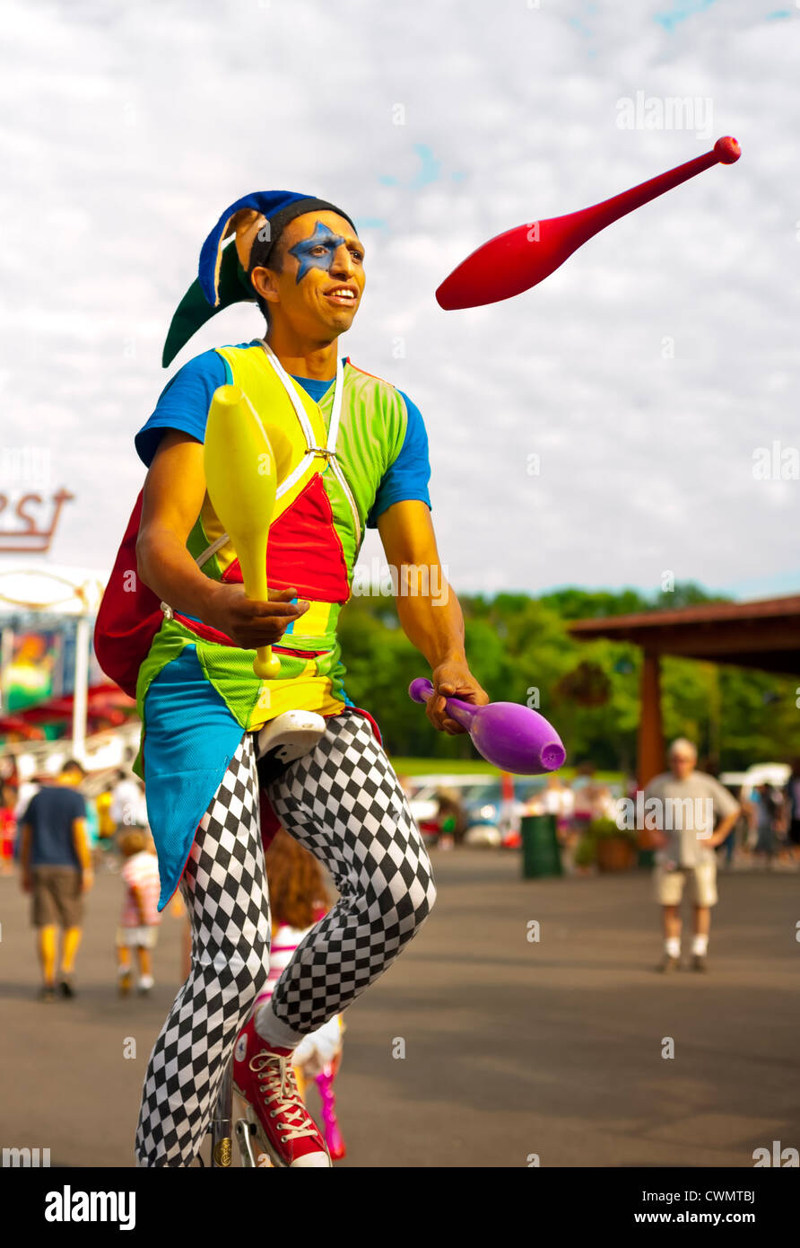 25 août 2012 - Middlebury, Vermont, États-Unis - jongleur en costume  d'Arlequin sur les broches de jonglerie monocycle à Quassy Amusement Park  Photo Stock - Alamy