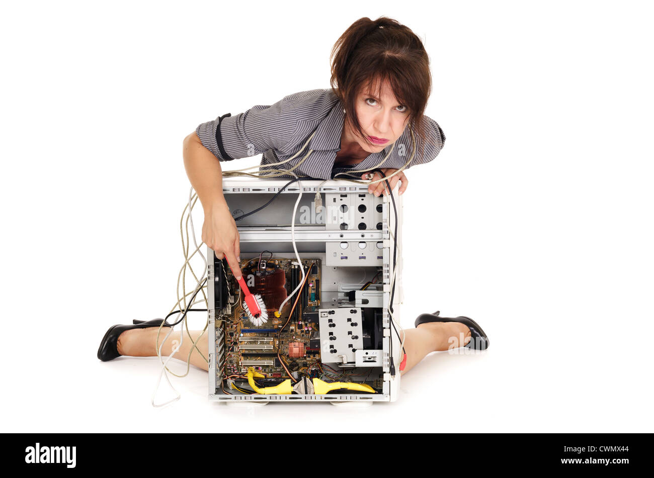 Une femme lave a souligné l'ordinateur à l'aide d'un pinceau de nettoyage Banque D'Images