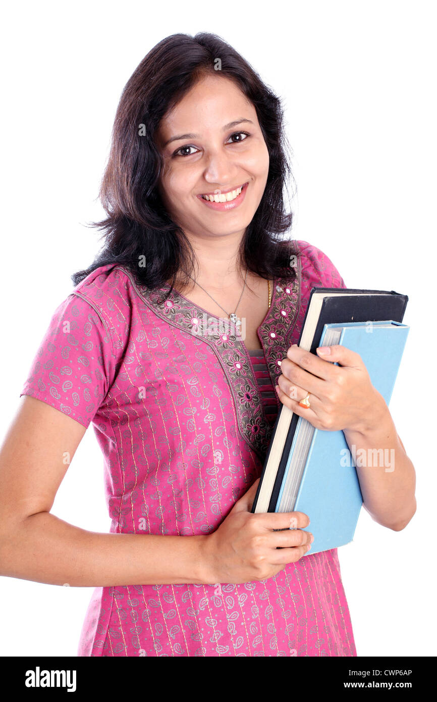 Smiling Indian female student holding books against white background Banque D'Images