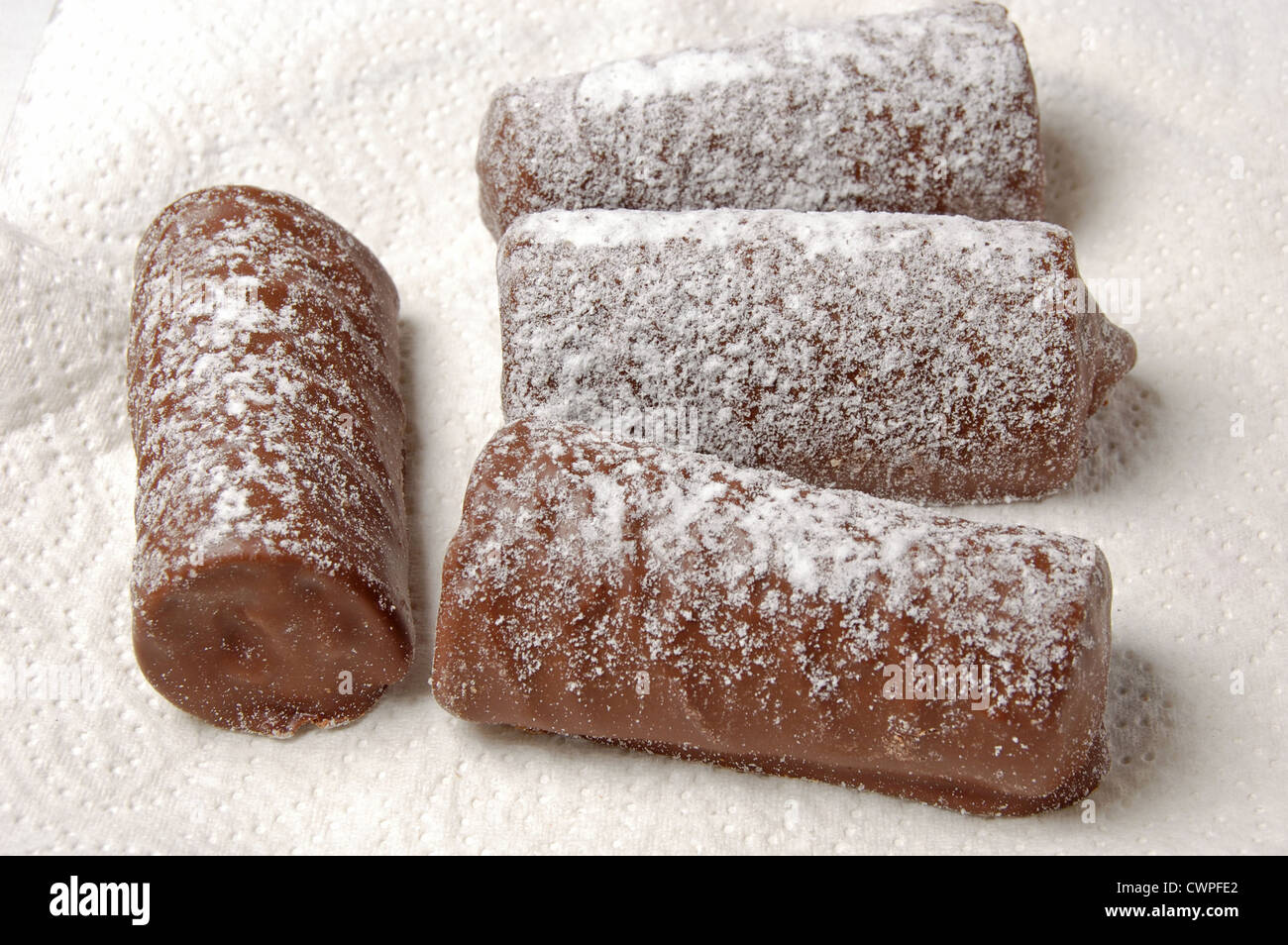 Les journaux au chocolat saupoudrés de sucre glace sur une serviette en papier Banque D'Images
