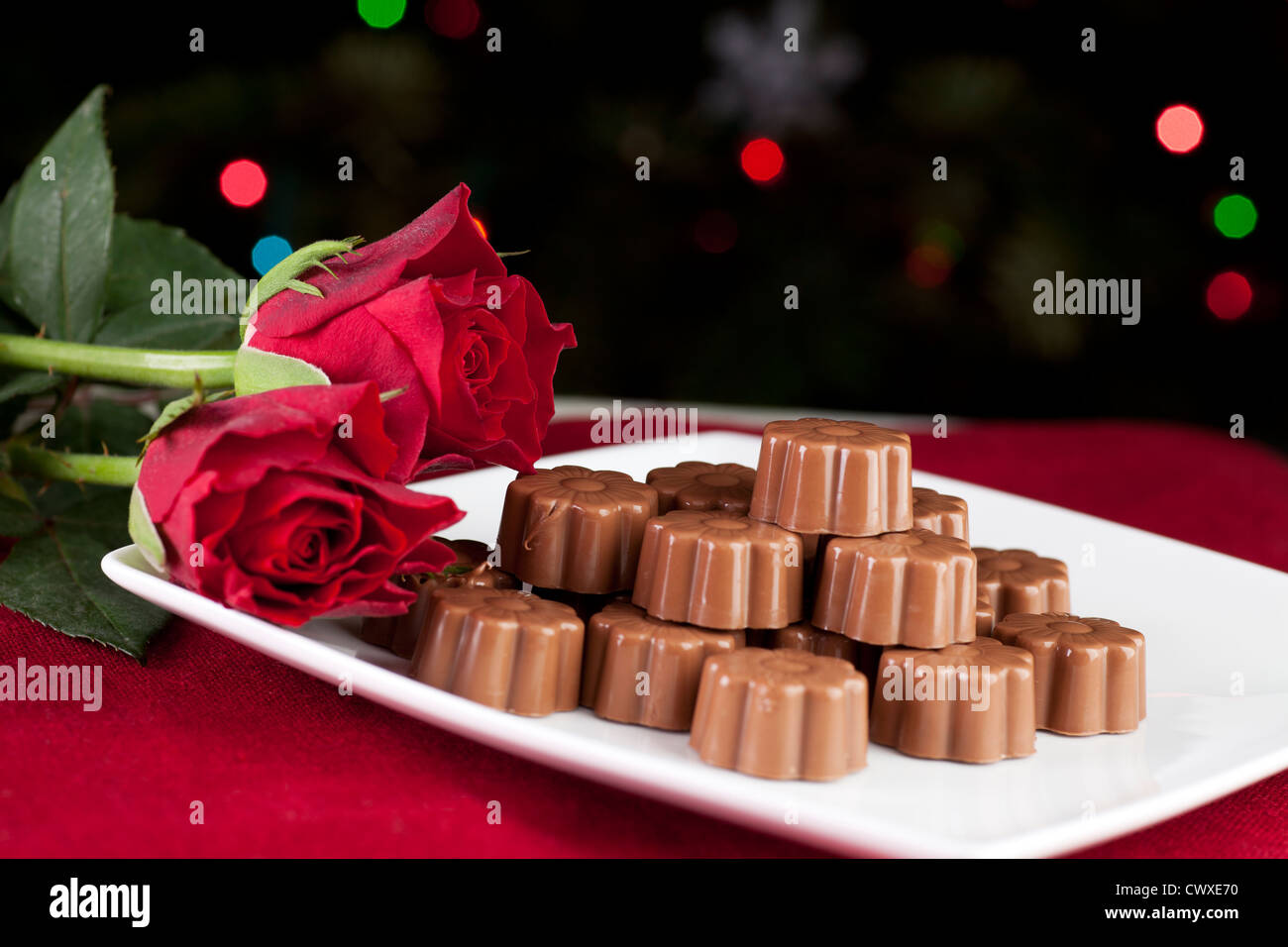 Chocolats et roses avec des collants à l'arrière-plan. Banque D'Images