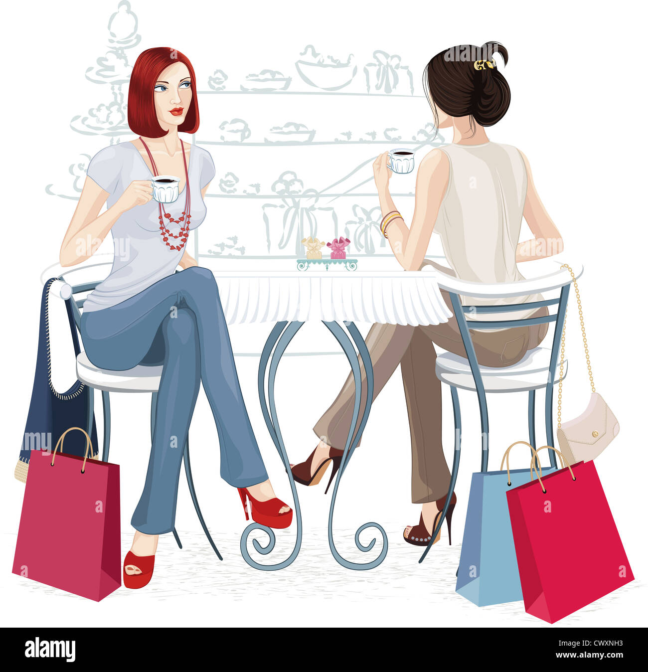 Deux jeunes femmes assises avec tasses de café à la table Banque D'Images