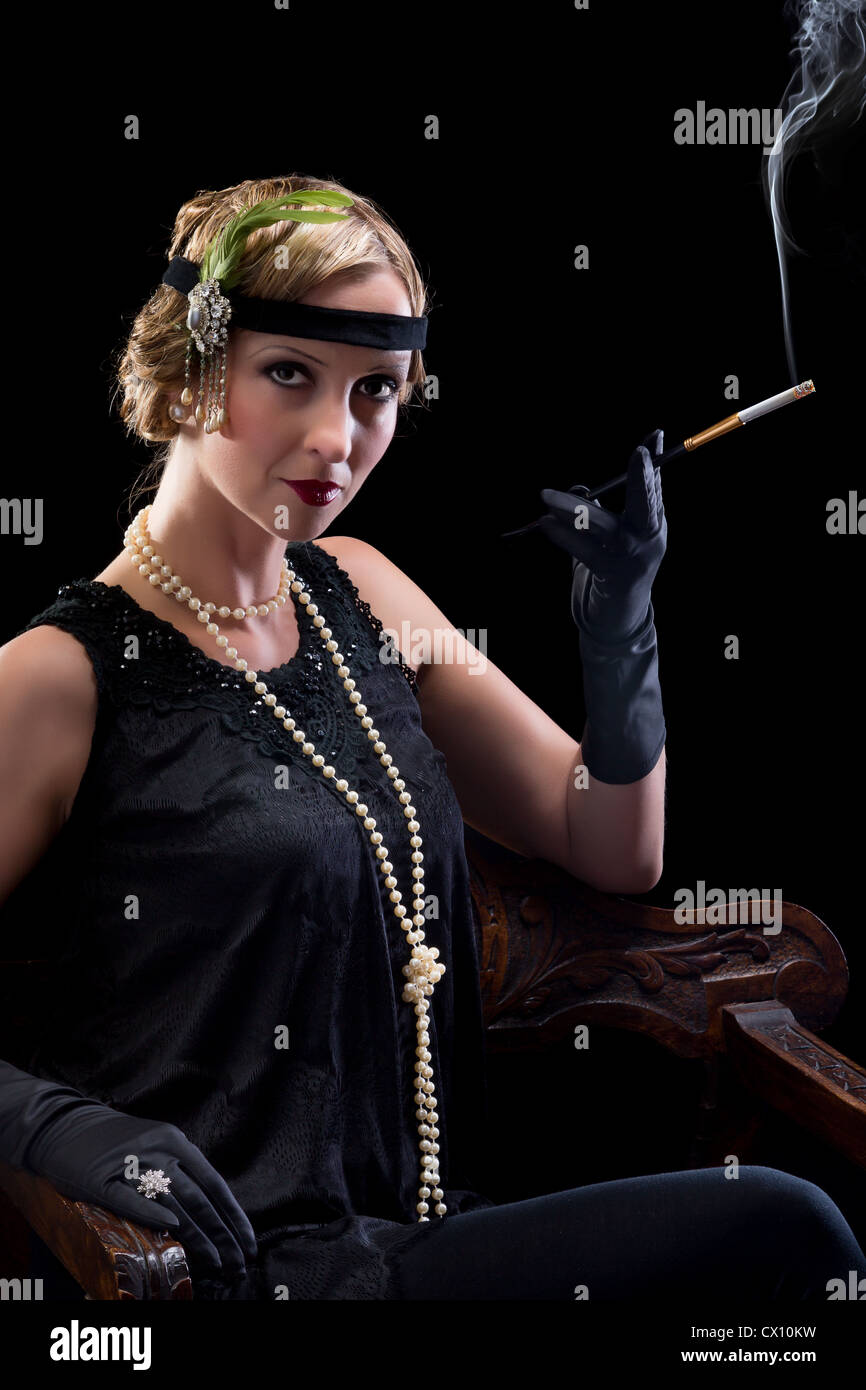 La vingtaine dame fumer une cigarette avec un porte-cigarette Photo Stock -  Alamy