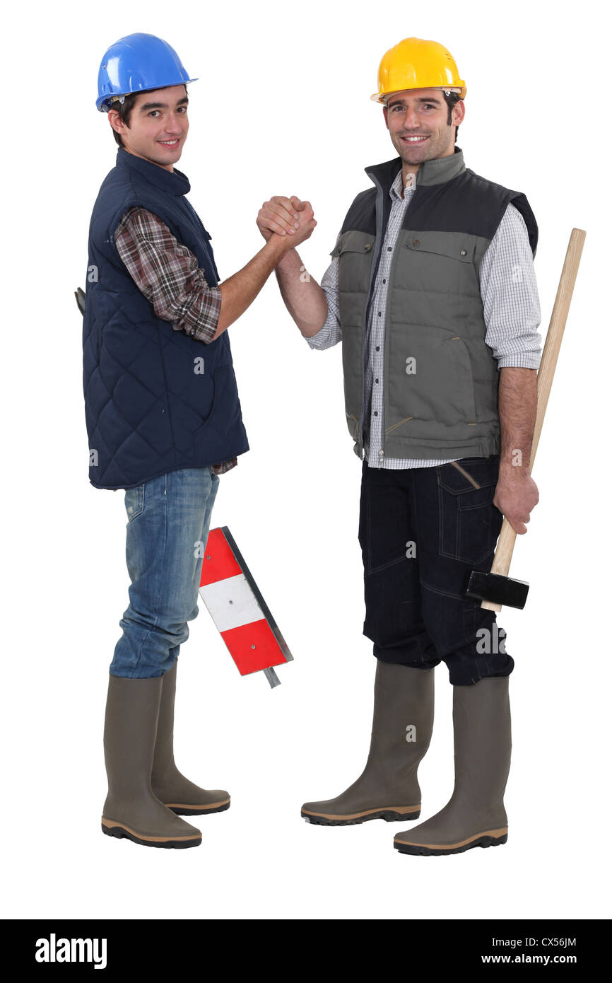 Construction colleagues shaking hands Banque D'Images